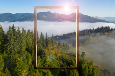 Image of Wooden frame and beautiful mountains with fog in morning