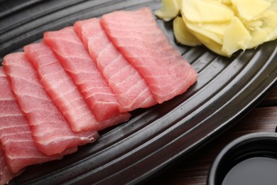 Photo of Tasty sashimi (pieces of fresh raw tuna) on plate, closeup