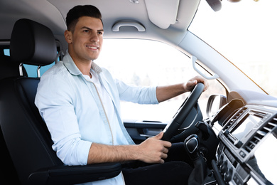 Photo of Handsome man driving his new modern car