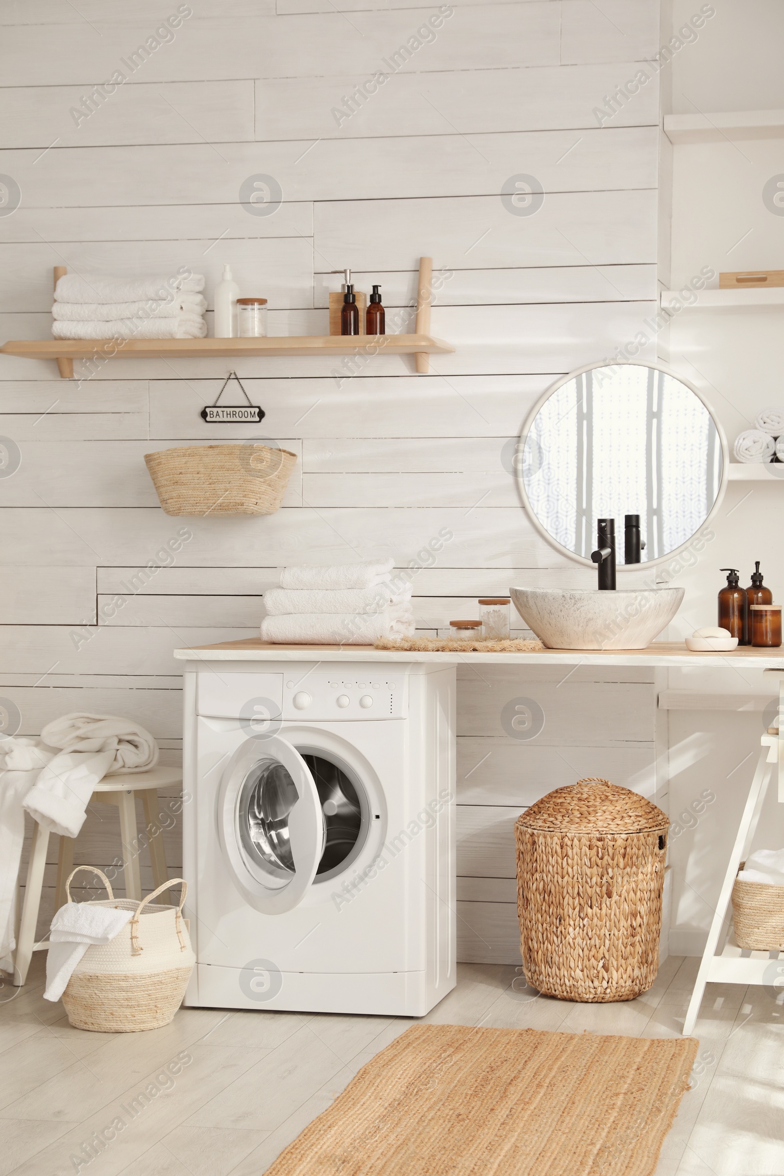 Photo of Stylish bathroom interior with modern washing machine