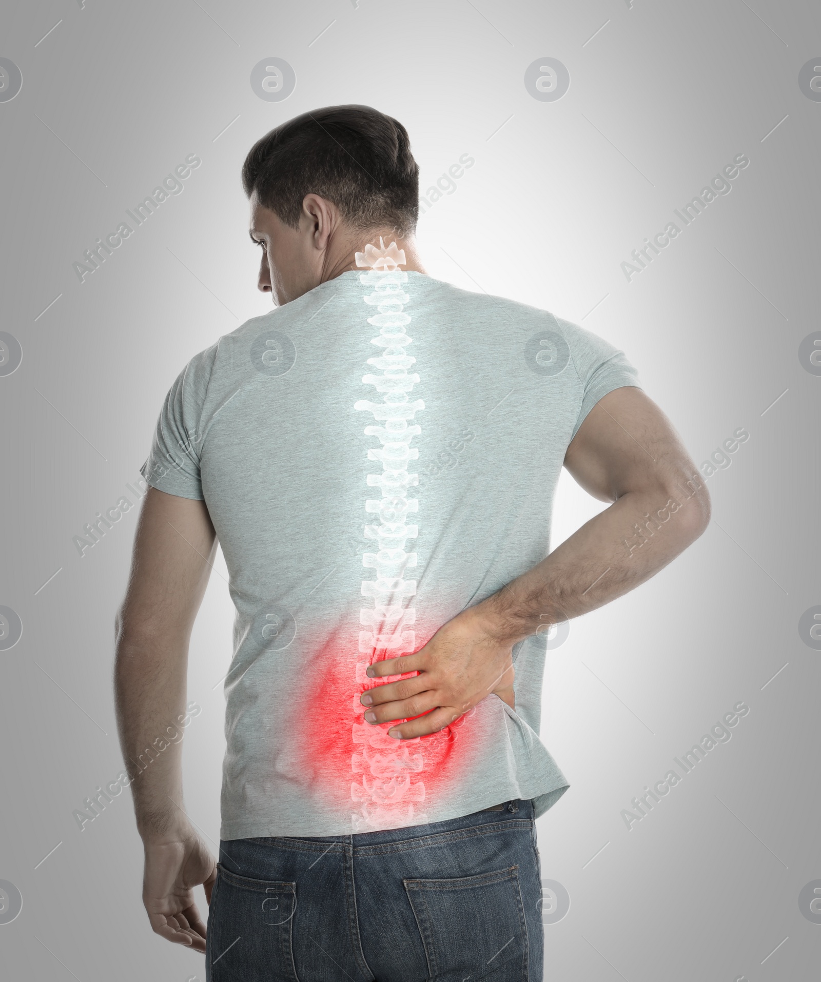 Image of Man suffering from pain in spine on grey background