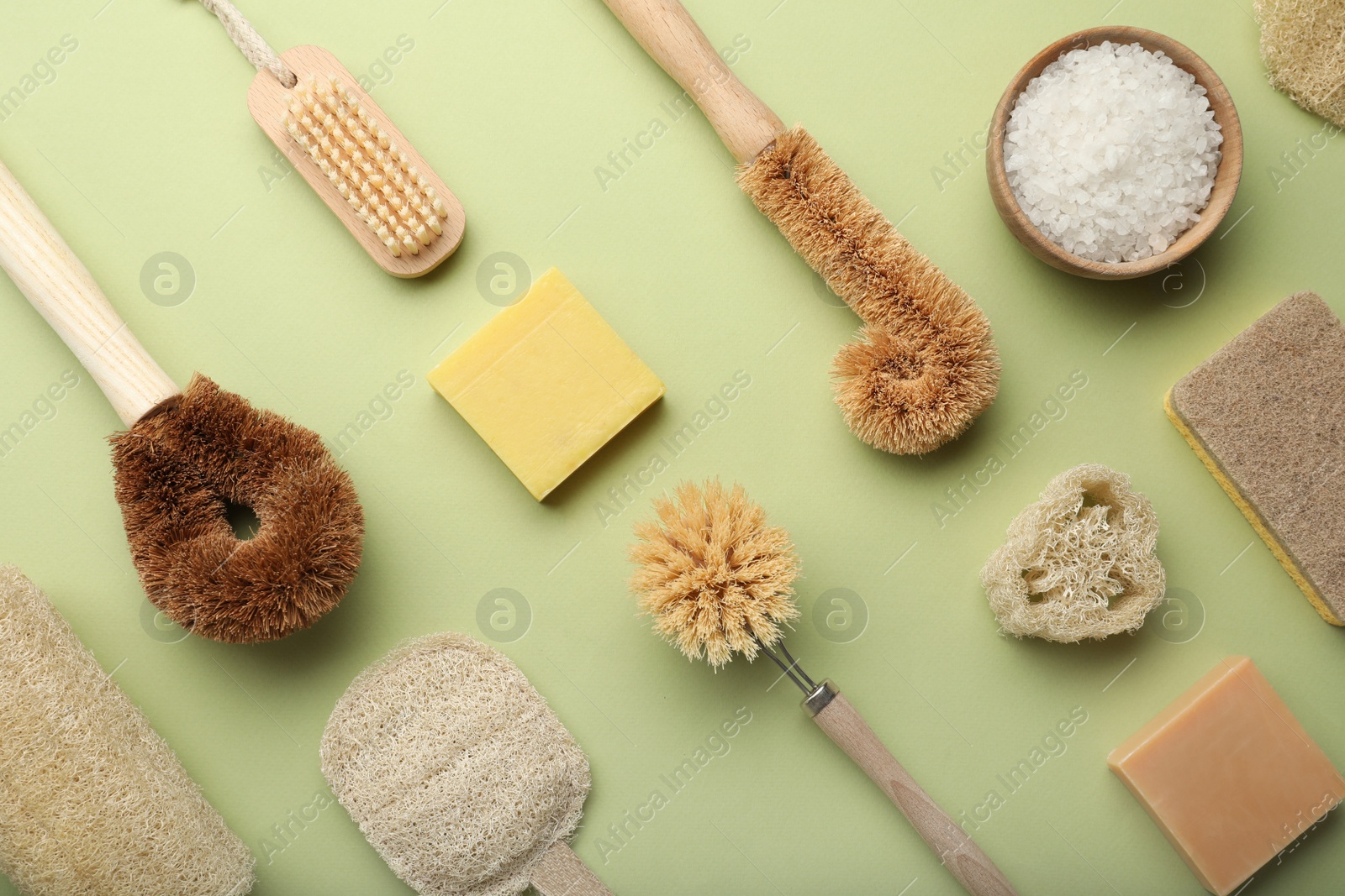 Photo of Flat lay composition with eco friendly products on green background