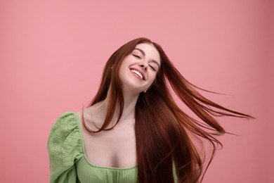 Photo of Portrait of smiling woman on pink background