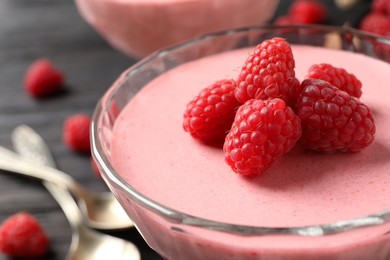 Photo of Glass of delicious raspberry mousse, closeup view