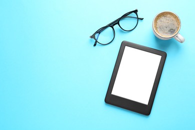 Photo of Modern e-book reader, glasses and coffee on turquoise background, flat lay. Space for text