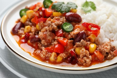 Photo of Plate of rice with chili con carne on table, closeup