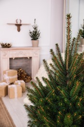 Photo of Beautiful living room interior with fireplace, focus on fir tree