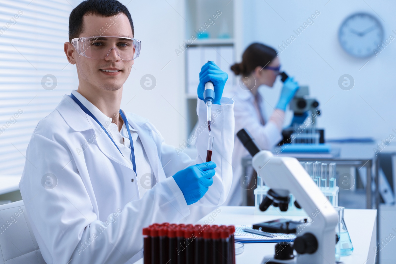 Photo of Scientist dripping sample into test tube in laboratory