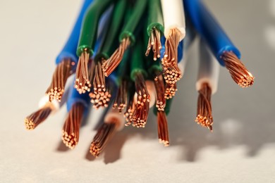 Photo of Electrical wires on light background, closeup view