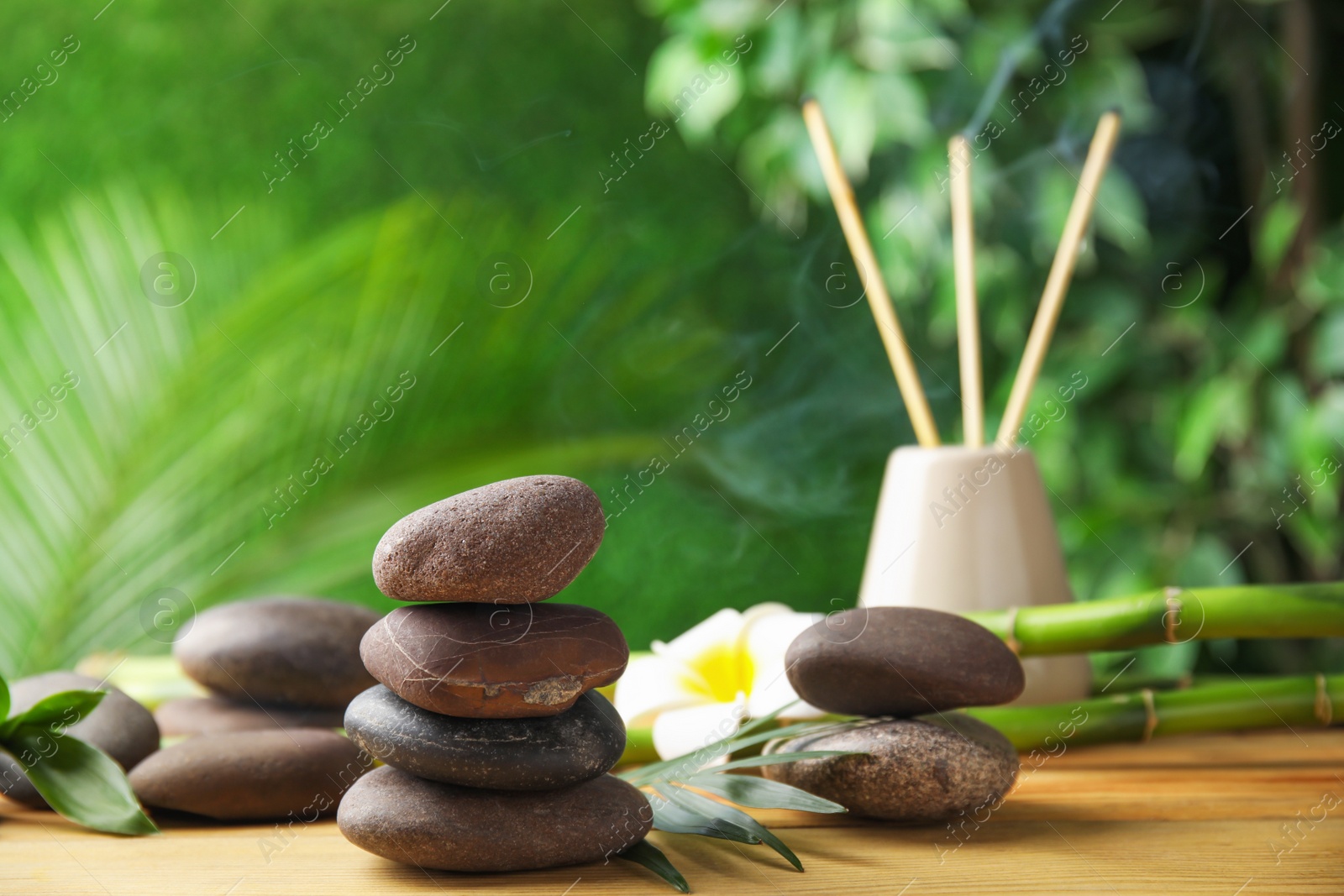 Photo of Composition with stones on table against blurred background. Zen concept