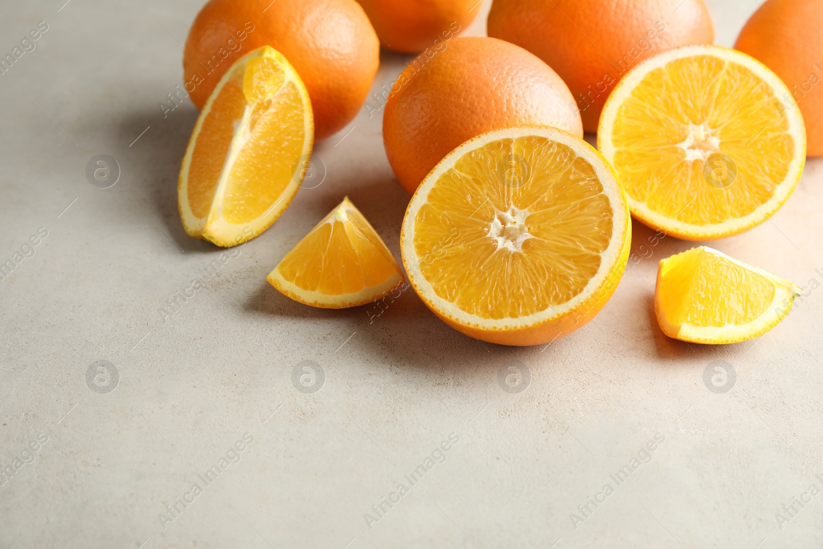 Photo of Fresh juicy oranges on table. Space for text