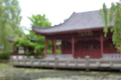 Photo of Beautiful view of oriental building near pond in park