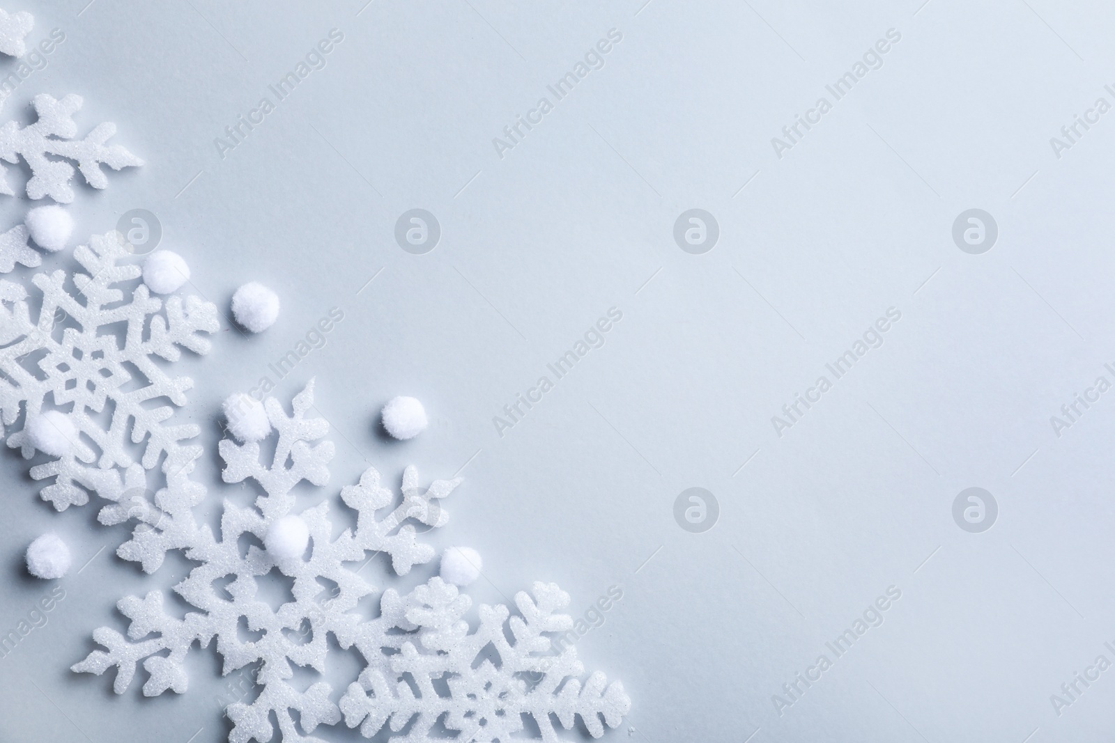 Photo of Beautiful snowflakes and decorative balls on white background, flat lay. Space for text