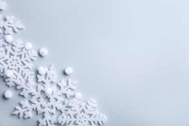 Photo of Beautiful snowflakes and decorative balls on white background, flat lay. Space for text