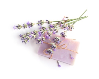Photo of Hand made soap bar with lavender flowers on white background, top view