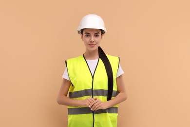 Engineer in hard hat on beige background