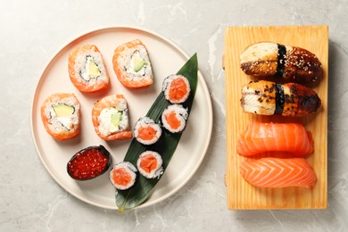 Photo of Delicious sushi rolls on white background, flat lay
