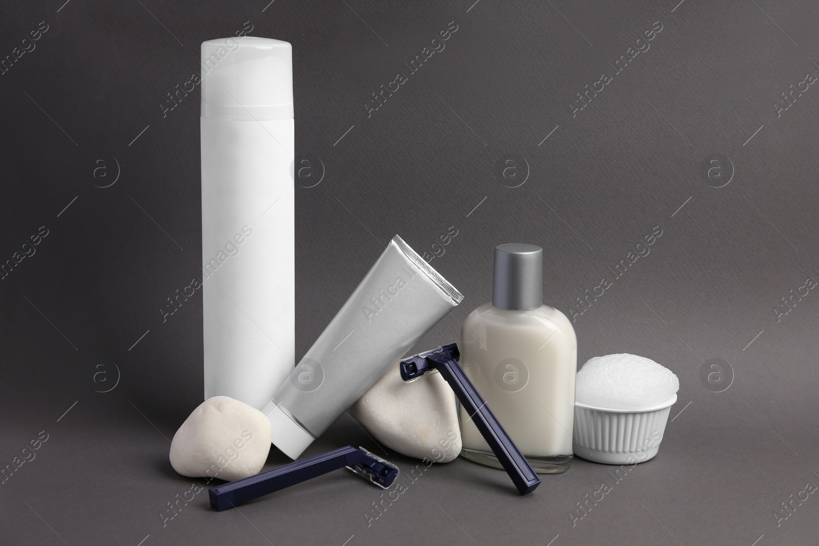 Photo of Different men's shaving accessories on dark grey background