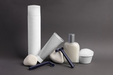 Different men's shaving accessories on dark grey background