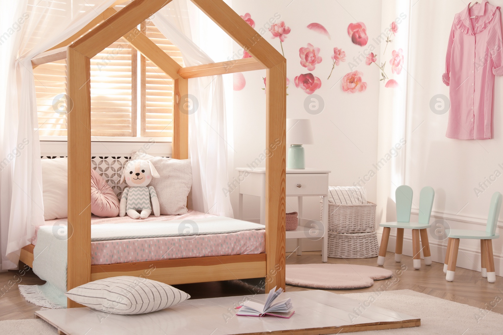 Photo of Stylish child room interior with wooden house bed