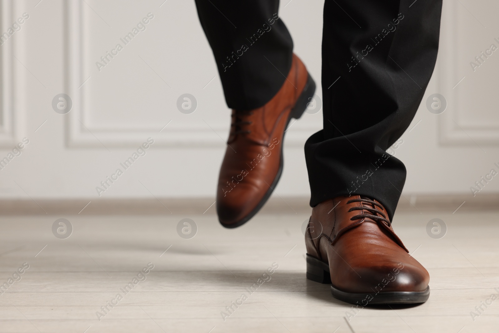 Photo of Businessman in elegant leather shoes indoors, closeup. Space for text