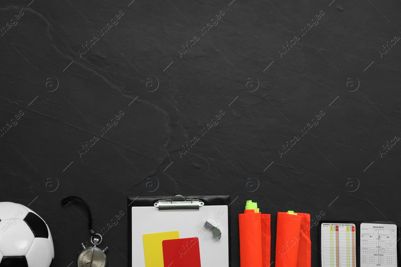 Photo of Different referee equipment on black table, flat lay. Space for text