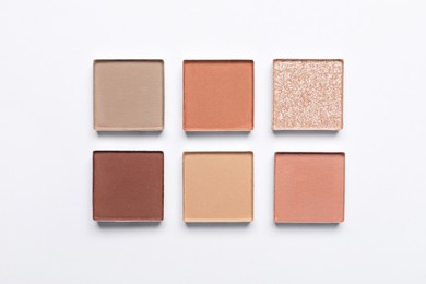 Beautiful eye shadow refill pans on white background, flat lay