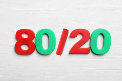 Photo of Colorful numbers 80 and 20 on white wooden background, flat lay. Pareto principle concept