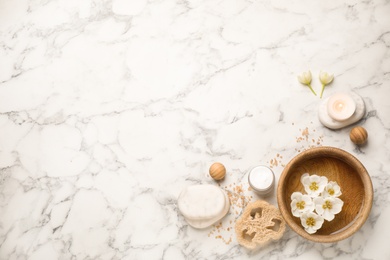 Photo of Flat lay spa composition with cream on white marble table, space for text