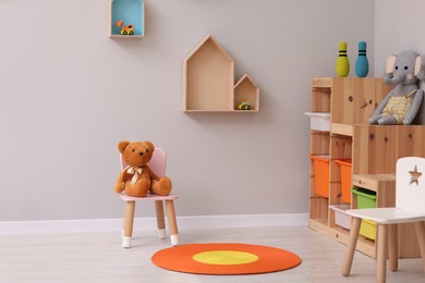 Photo of Child`s playroom with different toys and furniture. Cozy kindergarten interior