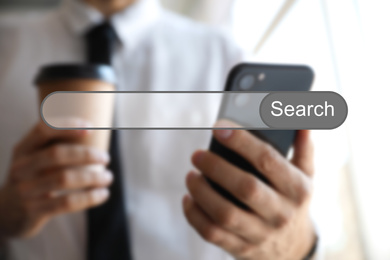 Image of Search bar of internet browser and man using smartphone indoors, closeup
