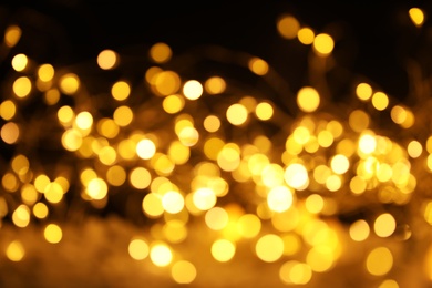 Gold glitter with bokeh effect on dark background