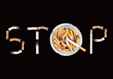Image of Quitting smoking concept. Word Stop made of burnt cigarettes and glass ashtray on black background, flat lay