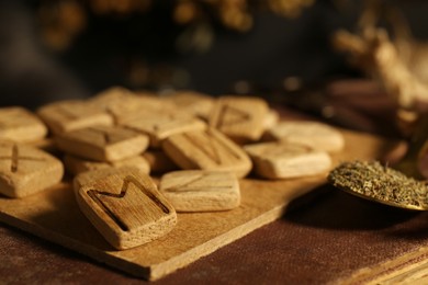 Many wooden runes on old book, closeup