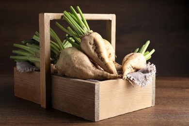 Photo of Basket with fresh sugar beets on wooden table