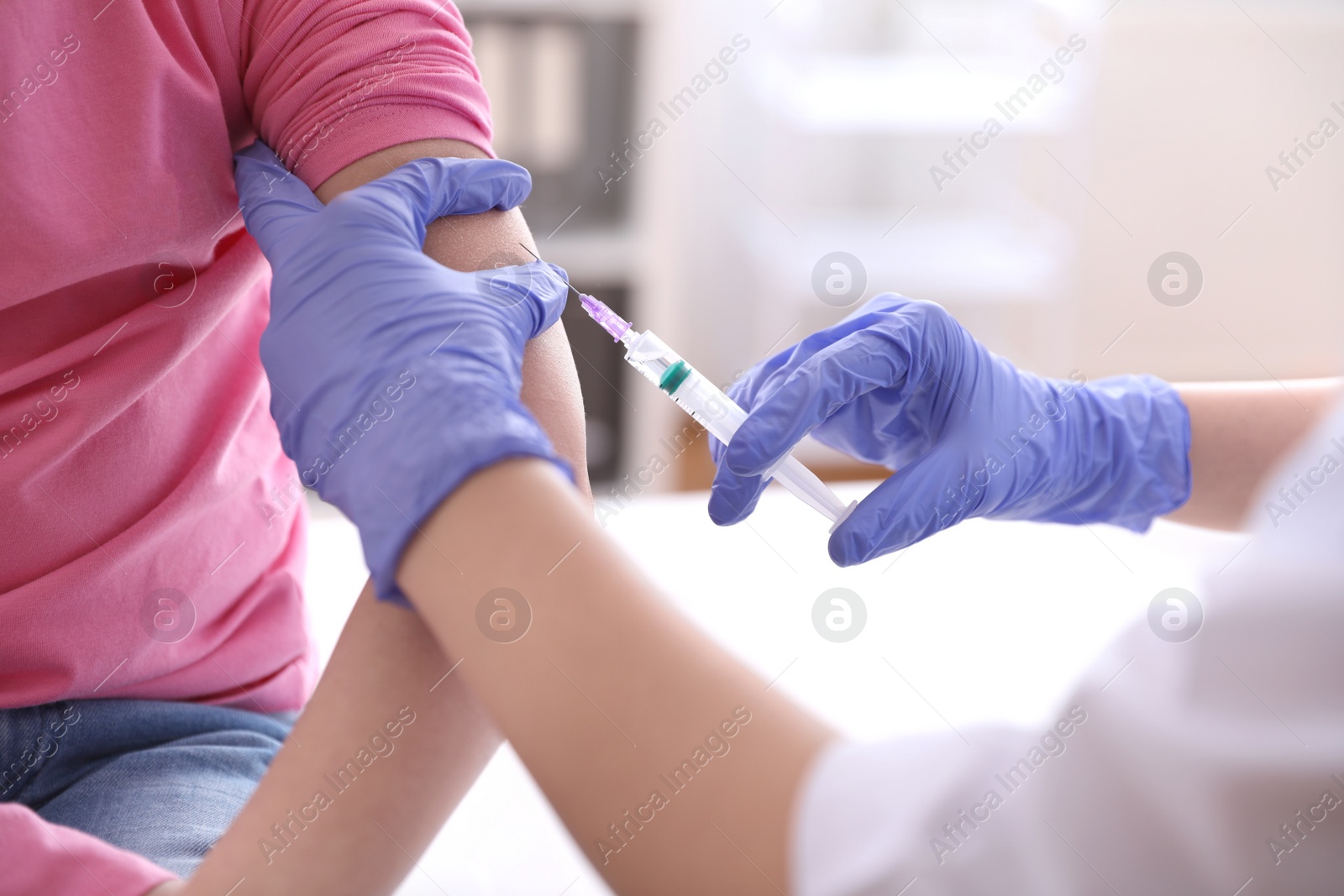 Photo of Little girl receiving chickenpox vaccination in clinic, closeup. Varicella virus prevention