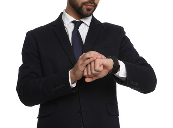 Photo of Young businessman checking time on white background, closeup