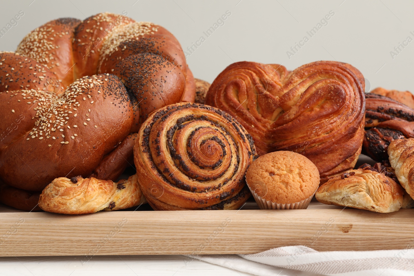 Photo of Different tasty freshly baked pastries on table