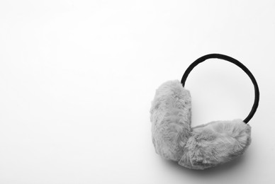 Photo of Stylish winter earmuffs on white background, top view. Space for text