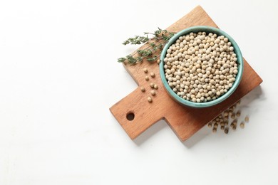 Photo of Aromatic spice. White pepper in bowl on white marble table, top view. Space for text