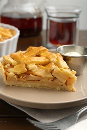 Piece of tasty homemade quince pie with ice cream on table, closeup