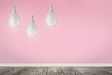 Stylish pendant lamps hanging near pink wall in room