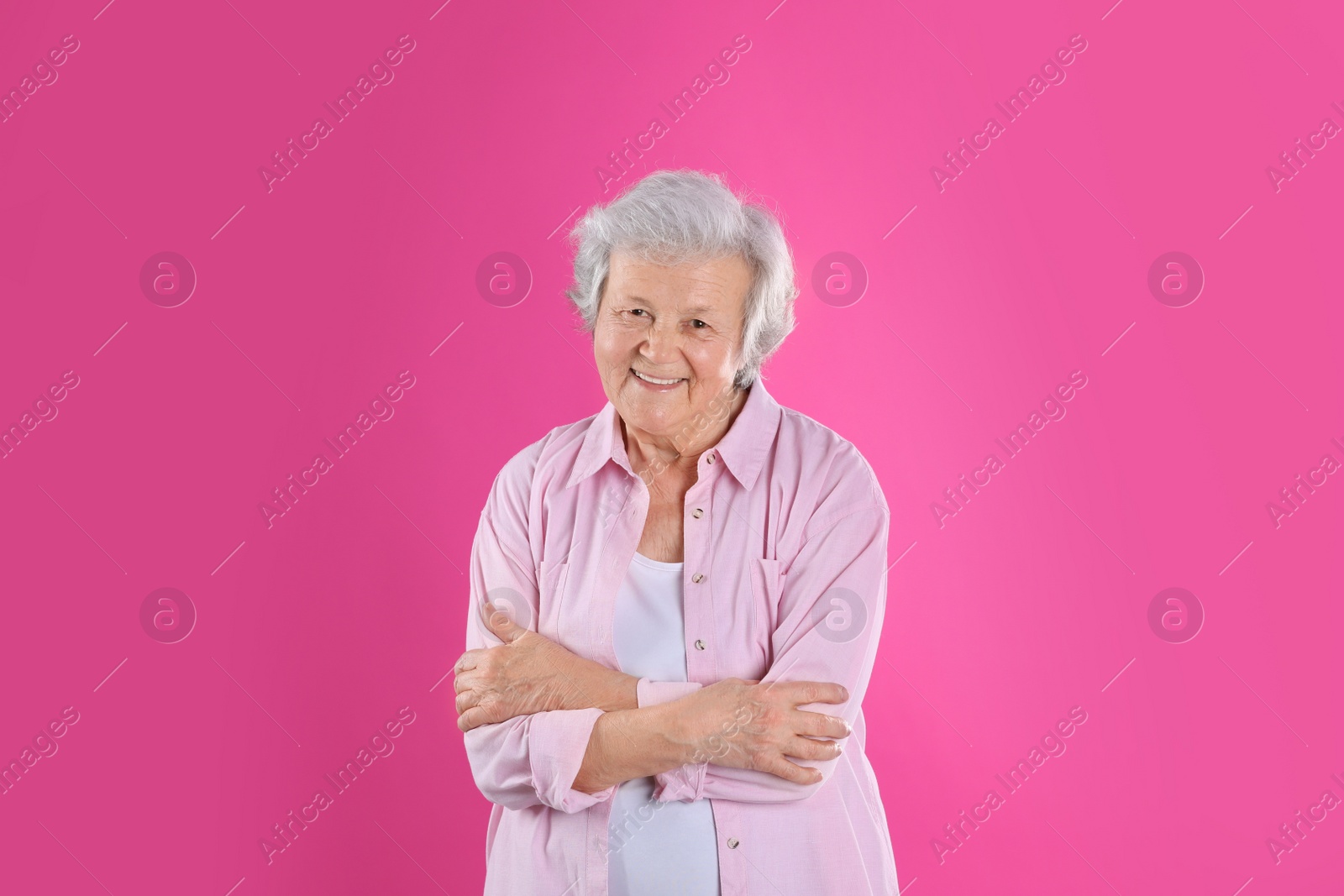Photo of Portrait of grandmother in stylish clothes on color background
