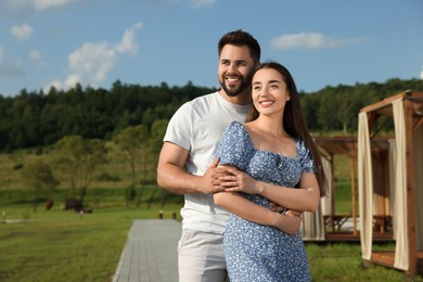 Photo of Romantic date. Beautiful couple spending time together outdoors, space for text