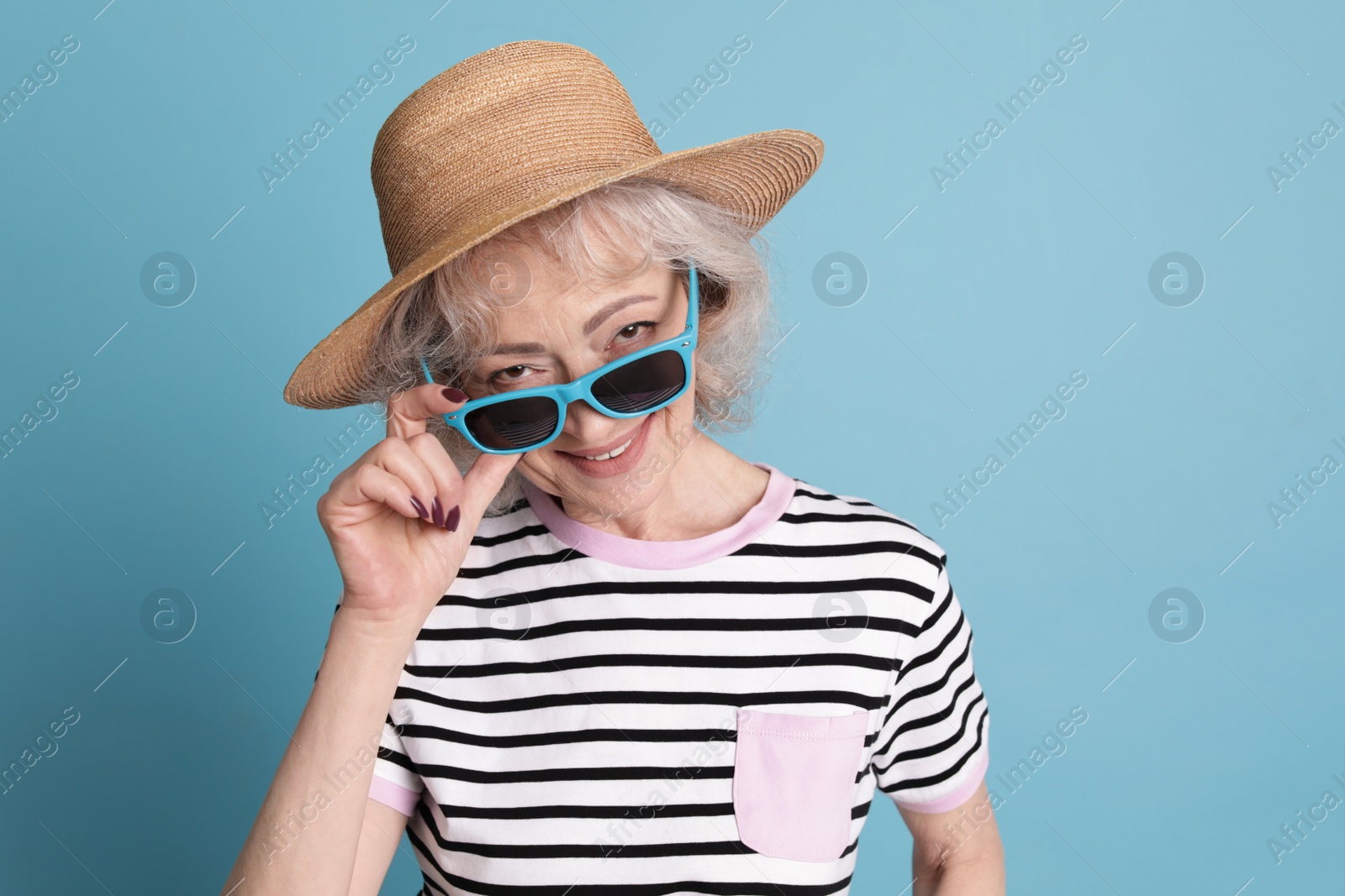 Photo of Portrait of mature woman in hipster outfit on color background