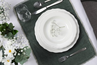 Photo of Elegant festive setting with floral decor on table, flat lay