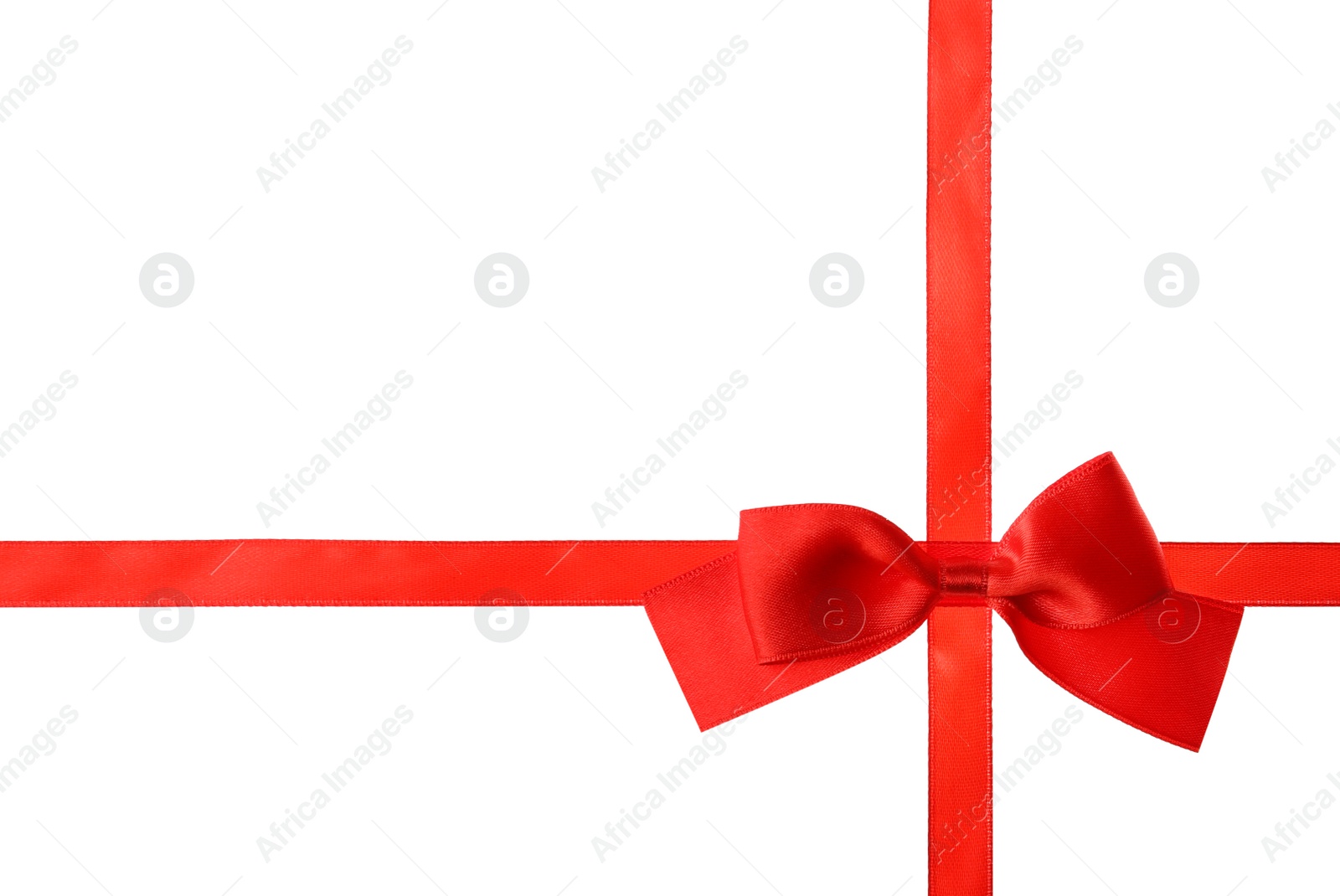 Photo of Red ribbon with bow on white background. Festive decoration