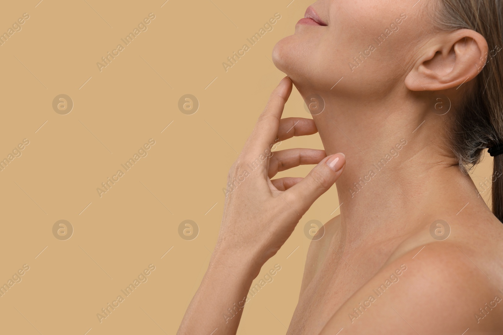 Photo of Mature woman with healthy skin on beige background, closeup. Space for text