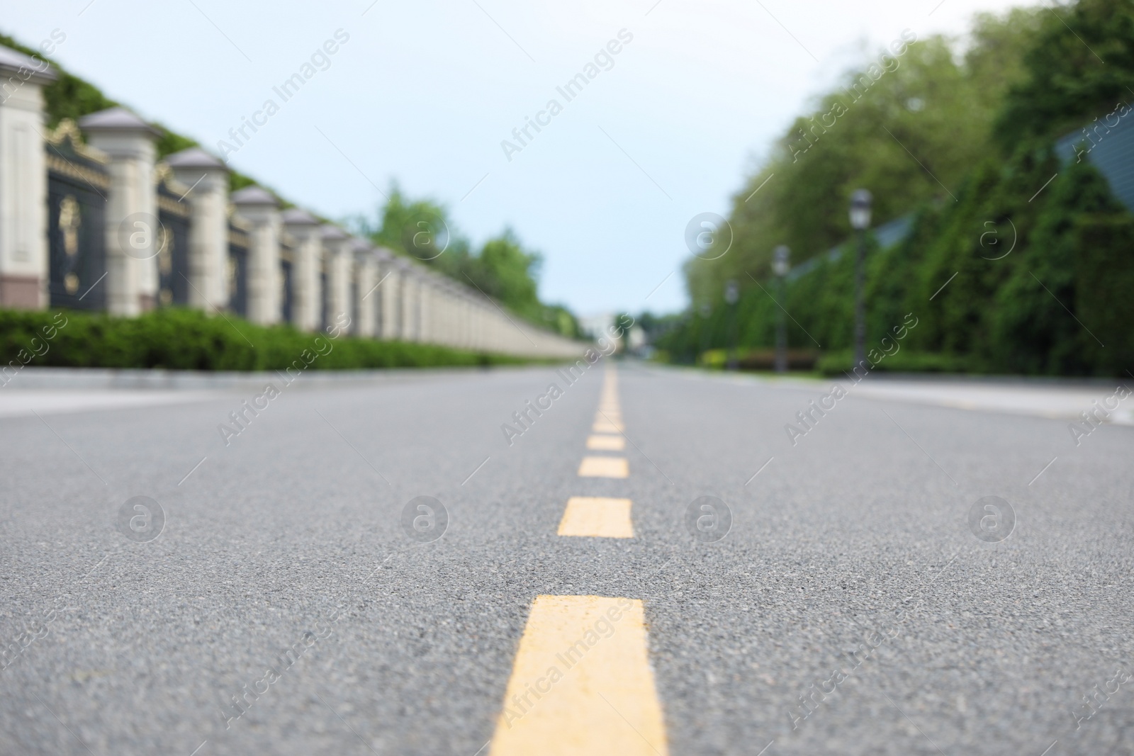 Photo of Yellow dividing lines on asphalt road in city