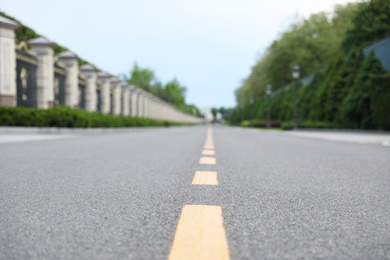 Yellow dividing lines on asphalt road in city